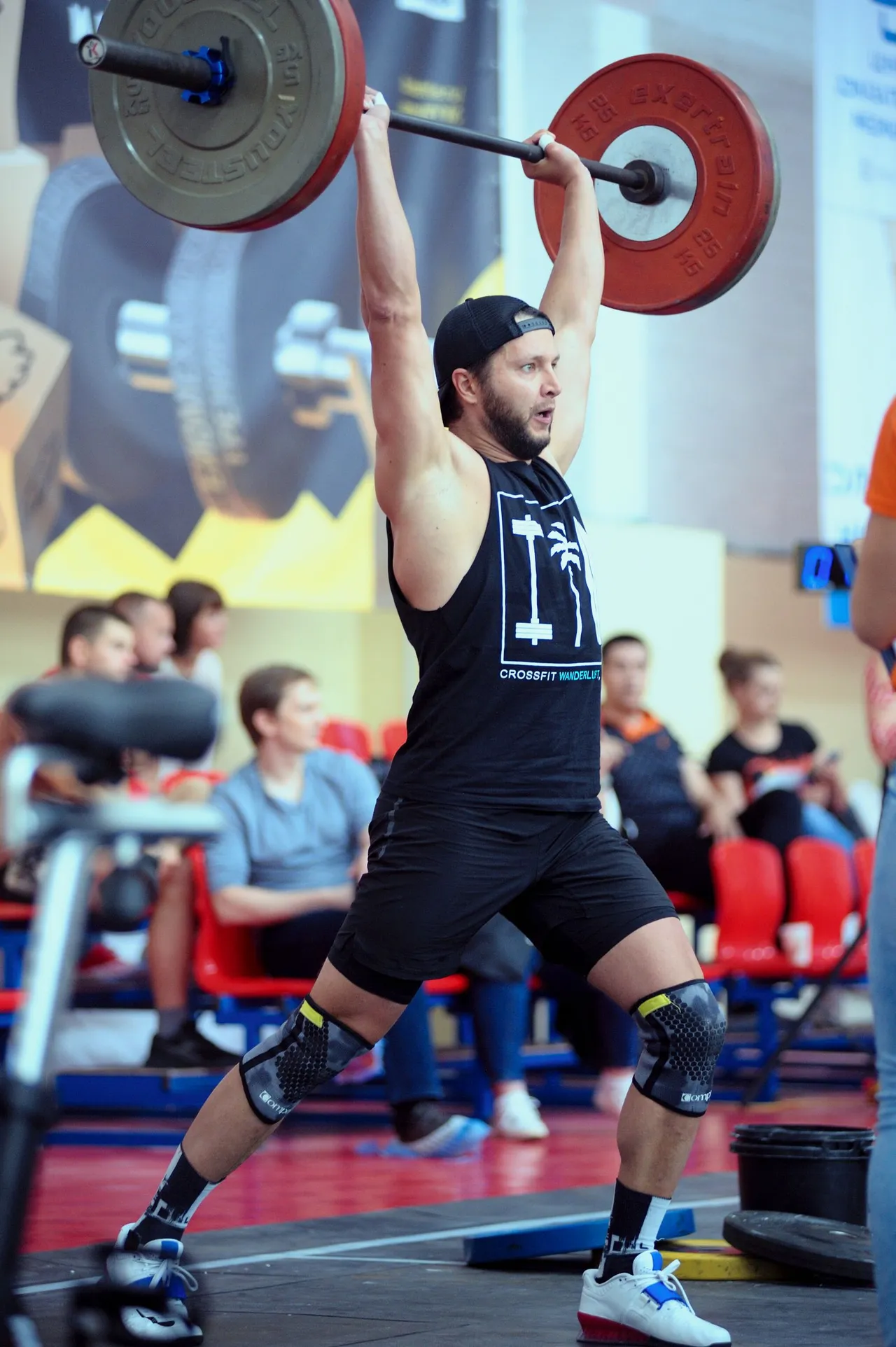 A strength athlete competing with a loaded barbell