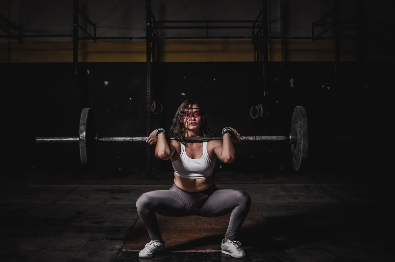 A woman lifting a loaded barbell