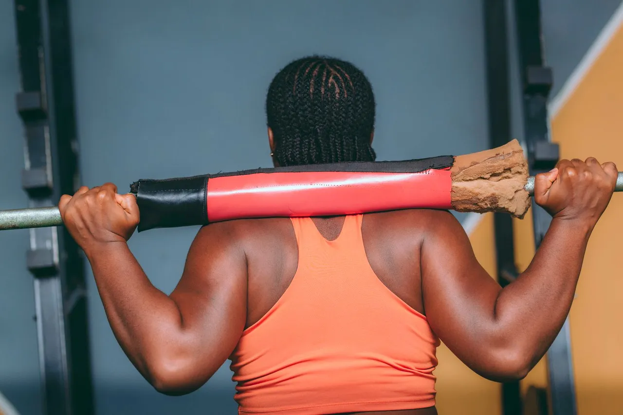 Rear view of a woman weightlifting in a gym