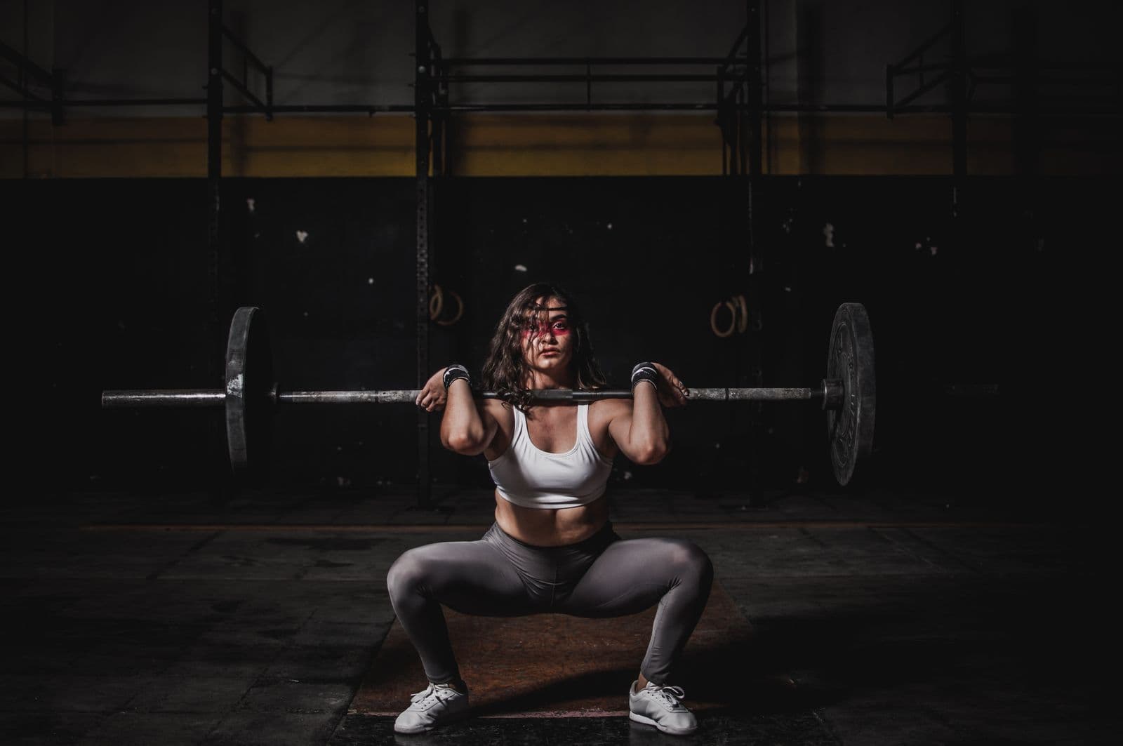 A woman lifting a loaded barbell